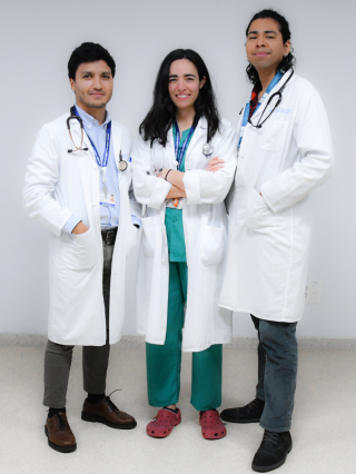 grupo de tres médicos con bata, dos hombre y una mujer